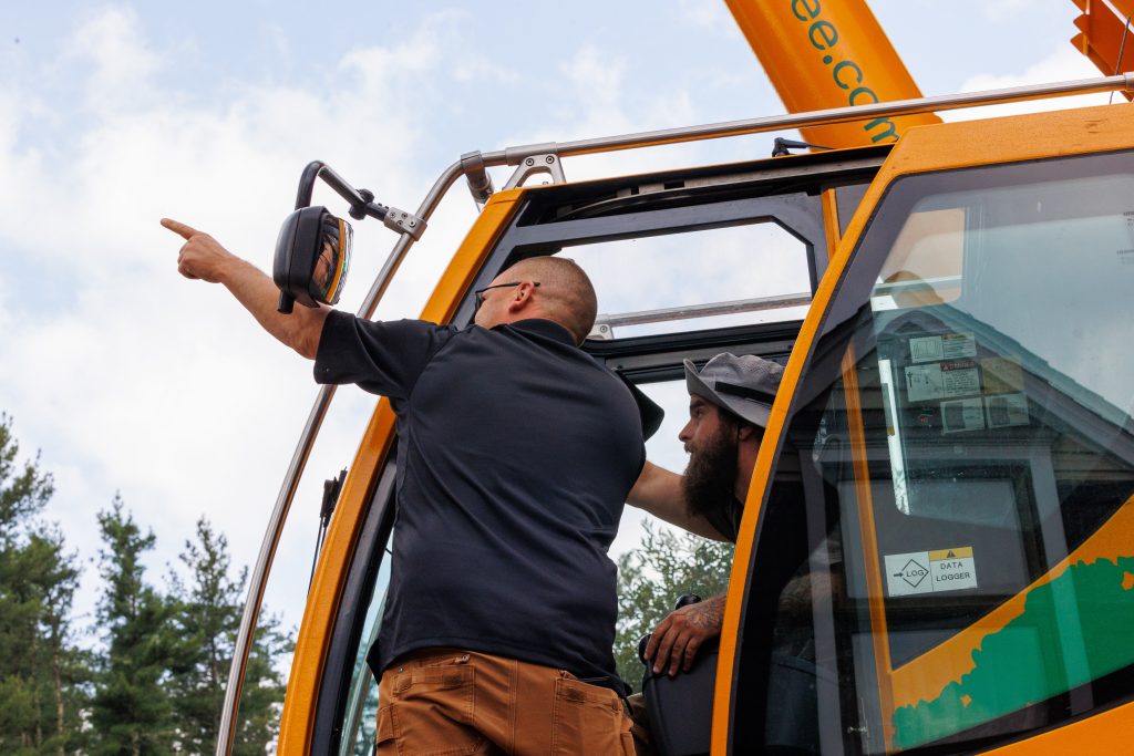 Team members inside a crane pointing