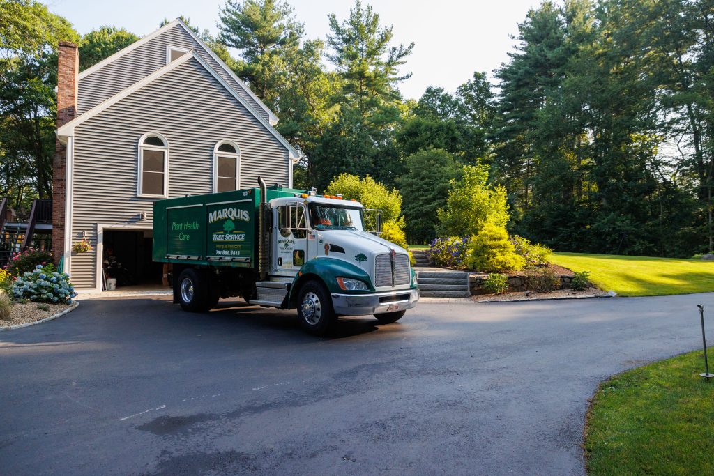 Marquis company truck by a residential neighborhood